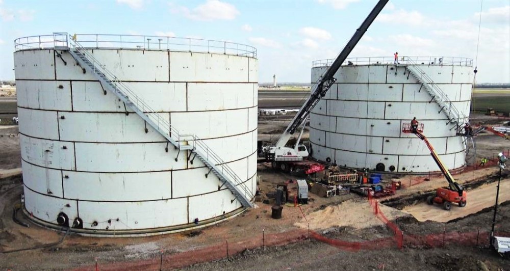 Two white fuel tanks with steel walls. 